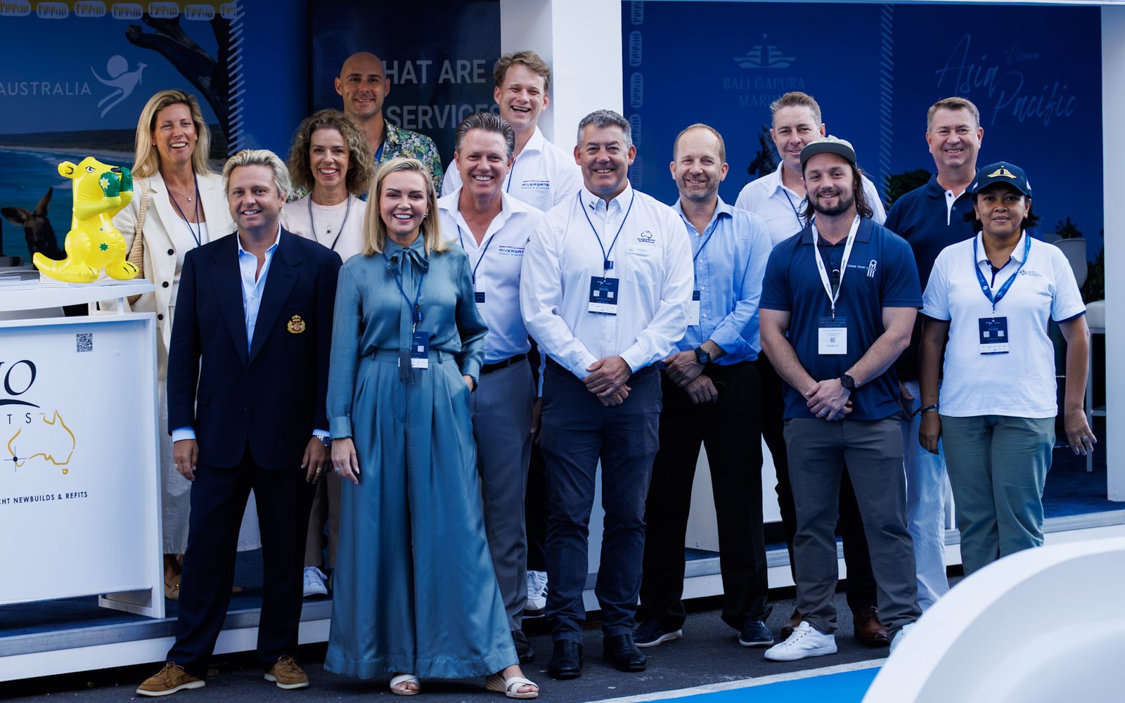 Exhibitors and guests of the Asia Pacific Stand stand together in front of the stand at the 2026 Monaco Yacht Show